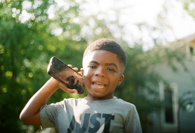 Autistic Black child with cell phone